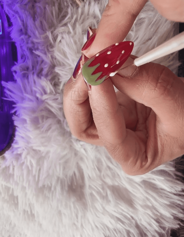 Applying the white seeds (Step 6). Expert Tip: If using a brush like this, keep your touch light. For ultimate varying size control (see tip below), I switched to my metal dotting tool after this shot!